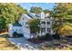 Charming two-story home boasts a welcoming front porch, attached garage, and landscaped front yard at 14027 Grand Traverse Dr, Charlotte, NC 28278
