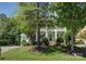 Charming two-story house with a well-manicured lawn, a two-story porch, and lush landscaping at 14027 Grand Traverse Dr, Charlotte, NC 28278