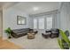 Inviting living room with dark leather seating, a round coffee table, crown molding, and large windows at 14027 Grand Traverse Dr, Charlotte, NC 28278
