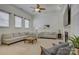 Spacious living room with plush seating, a fireplace, and large windows offering plenty of natural light at 14027 Grand Traverse Dr, Charlotte, NC 28278