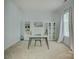 Bright office space with neutral walls, carpet, and built-in shelving next to a window and white curtains at 14027 Grand Traverse Dr, Charlotte, NC 28278