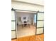 Home office featuring neutral walls, carpet, and a sliding barn door to the hall, with built-in shelving at 14027 Grand Traverse Dr, Charlotte, NC 28278
