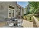 Outdoor seating on deck with four chairs and small table overlooking fenced backyard and home exterior at 14027 Grand Traverse Dr, Charlotte, NC 28278