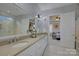 Double vanity bathroom with a view into a bedroom at 14535 Crosswater Ln, Charlotte, NC 28278