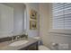 Powder room with a single vanity and window at 14535 Crosswater Ln, Charlotte, NC 28278