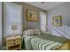 Bedroom with green bedding, wood nightstands, and window shutters at 14535 Crosswater Ln, Charlotte, NC 28278