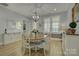 Formal dining room with a round wooden table and white chairs at 14535 Crosswater Ln, Charlotte, NC 28278