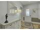 Bright entryway with a white console table, mirror, and hardwood floors at 14535 Crosswater Ln, Charlotte, NC 28278