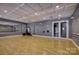 Bright and airy exercise room with hardwood floors, mirrors, and barre at 14535 Crosswater Ln, Charlotte, NC 28278