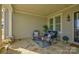 Relaxing front porch with stone flooring and wicker furniture at 14535 Crosswater Ln, Charlotte, NC 28278