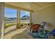 Covered porch with stone patio, wicker chairs, and a view of the street at 14535 Crosswater Ln, Charlotte, NC 28278