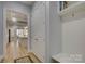 Bright hallway with view into kitchen and access to laundry and closets at 14535 Crosswater Ln, Charlotte, NC 28278