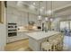 Bright kitchen featuring white cabinets, center island, and hardwood floors at 14535 Crosswater Ln, Charlotte, NC 28278