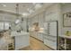 Modern kitchen with white cabinets, island seating, and stainless steel appliances at 14535 Crosswater Ln, Charlotte, NC 28278