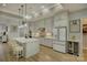 Modern kitchen with white cabinets, quartz countertops, and stainless steel appliances at 14535 Crosswater Ln, Charlotte, NC 28278