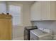 Laundry room with washer, dryer, and white cabinets at 14535 Crosswater Ln, Charlotte, NC 28278