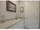 Laundry room with white cabinets, quartz countertop, and sink at 14535 Crosswater Ln, Charlotte, NC 28278