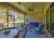 Relaxing screened porch with seating area and ceiling fan at 14535 Crosswater Ln, Charlotte, NC 28278