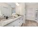 Double vanity bathroom with granite countertops and a shower at 5723 Wallace Cabin Dr, Charlotte, NC 28212