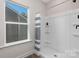 Shower stall with gray and white striped curtain and built-in shelving at 5723 Wallace Cabin Dr, Charlotte, NC 28212