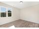 Simple bedroom with hardwood floors and large window at 5723 Wallace Cabin Dr, Charlotte, NC 28212