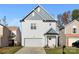 Two-story house with gray and white siding, a two-car garage, and a landscaped yard at 5723 Wallace Cabin Dr, Charlotte, NC 28212