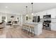 Open concept kitchen with white cabinets, granite countertops, and stainless steel appliances at 5723 Wallace Cabin Dr, Charlotte, NC 28212