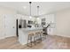 Modern kitchen with white cabinets, granite countertops, and stainless steel appliances at 5723 Wallace Cabin Dr, Charlotte, NC 28212