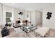 Living room with neutral decor, a glass coffee table, and a cozy seating arrangement at 5723 Wallace Cabin Dr, Charlotte, NC 28212