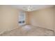 Bright bedroom with a ceiling fan and large window at 7141 Stonington Ln, Charlotte, NC 28227