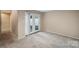 Carpeted bedroom with access to private patio at 7141 Stonington Ln, Charlotte, NC 28227