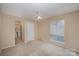 Spacious bedroom with ceiling fan and ensuite bathroom access at 7141 Stonington Ln, Charlotte, NC 28227