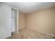 Simple bedroom with sliding door closet and neutral walls at 7141 Stonington Ln, Charlotte, NC 28227