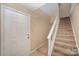 Front entry with staircase and neutral carpeting at 7141 Stonington Ln, Charlotte, NC 28227