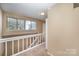 Upper hallway with window and stairs at 7141 Stonington Ln, Charlotte, NC 28227