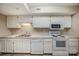 White kitchen with appliances and tile flooring at 7141 Stonington Ln, Charlotte, NC 28227