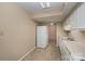 White kitchen with appliances and tile flooring at 7141 Stonington Ln, Charlotte, NC 28227