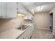 White kitchen with appliances and tile flooring at 7141 Stonington Ln, Charlotte, NC 28227