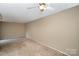 Spacious living room with ceiling fan and neutral walls at 7141 Stonington Ln, Charlotte, NC 28227