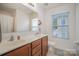 Bathroom with double sinks, a shower/tub combo, and a window at 14423 Glendon Hall Ln, Charlotte, NC 28262