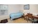 Small bedroom with a single bed, desk and window at 14423 Glendon Hall Ln, Charlotte, NC 28262