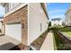 Charming home showcasing stone accents, manicured landscaping, and an attached two car garage at 14423 Glendon Hall Ln, Charlotte, NC 28262