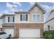 Two-story townhome with attached garage and stone accents at 14423 Glendon Hall Ln, Charlotte, NC 28262