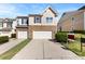 Inviting home featuring a stone facade, a two-car garage, and well-maintained landscaping at 14423 Glendon Hall Ln, Charlotte, NC 28262