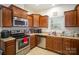 Modern kitchen with stainless steel appliances and corner sink at 14423 Glendon Hall Ln, Charlotte, NC 28262