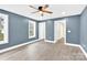 Blue bedroom with hardwood floors and access to a bathroom at 2668 Polo Ln, Maiden, NC 28650