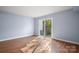 Light-filled bedroom with hardwood floors and access to a private patio at 2705 North Center St # 74, Hickory, NC 28601
