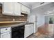 White kitchen cabinets, wood-look backsplash, and stainless steel appliances at 2705 North Center St # 74, Hickory, NC 28601
