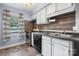 Galley kitchen with wood-look backsplash and modern appliances at 2705 North Center St # 74, Hickory, NC 28601