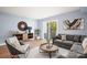 Bright living room with wood floors, comfy seating, and sliding glass door to patio at 2705 North Center St # 74, Hickory, NC 28601